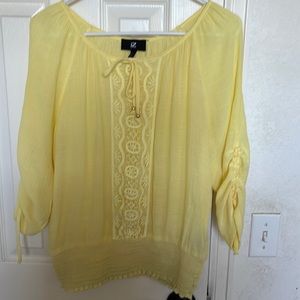 Yellow top with Lacey front and tie neck and sleeves.